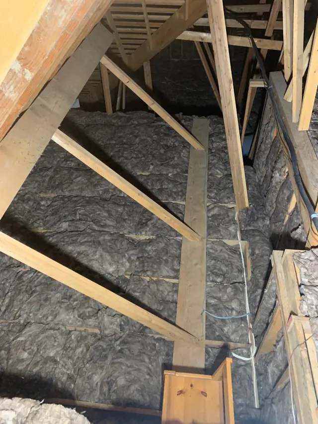 New loose-fill insulation installed between the trusses