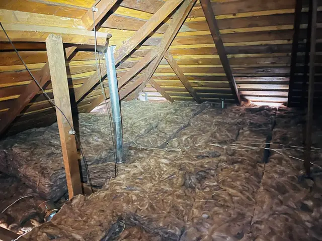Attic insulated wall to wall after cleanup