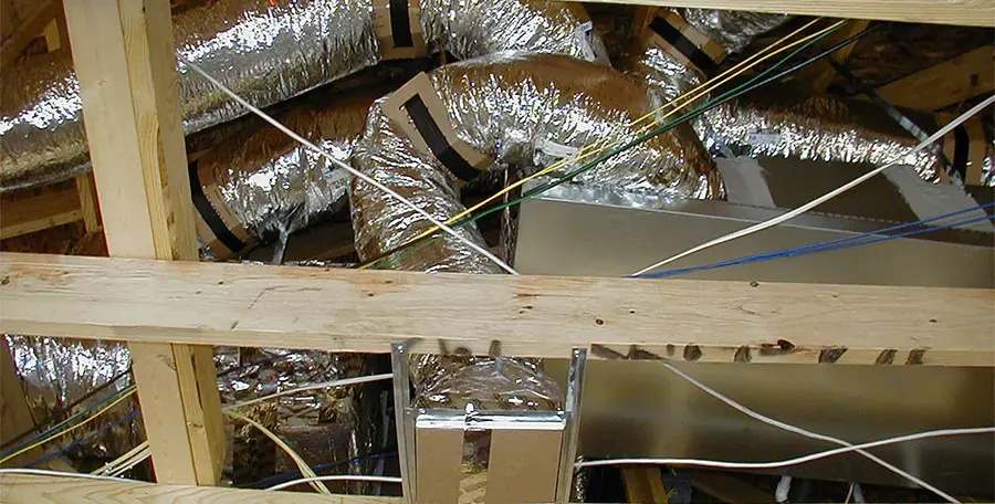 New insulated ducts run through a cleaned-out attic.