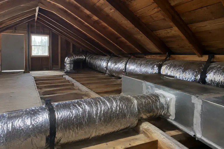Air duct replacement in a Tacoma craftsman bungalow attic, after: The finished new air duct system improves attic airflow and energy efficiency, completing the replacement with professional quality.