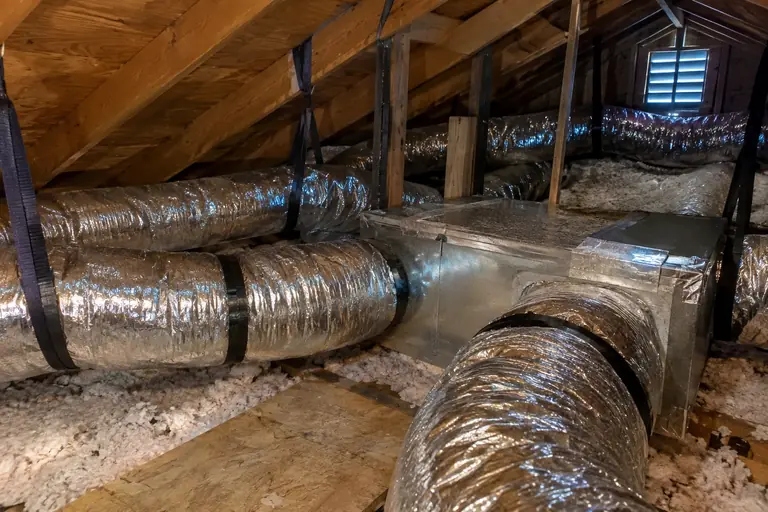New insulated flex ducts and sheet-metal trunks in an attic.