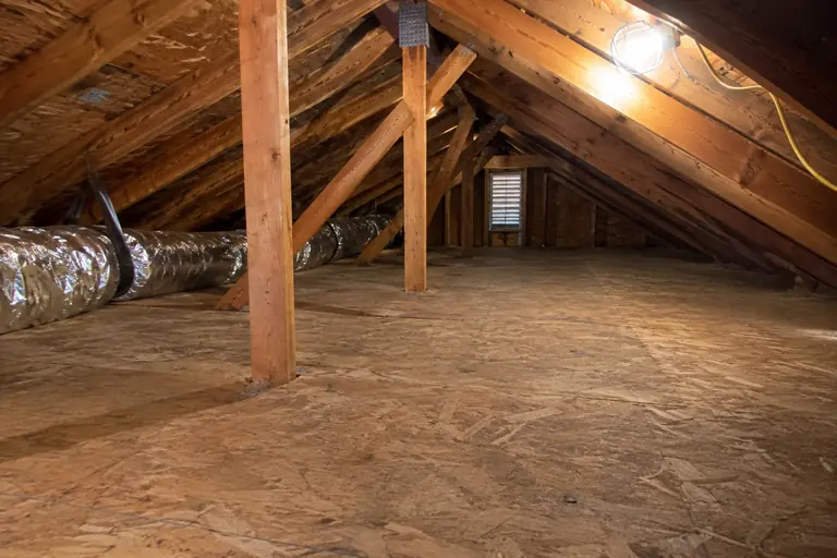 An attic vacuumed clean, ready for new insulation.