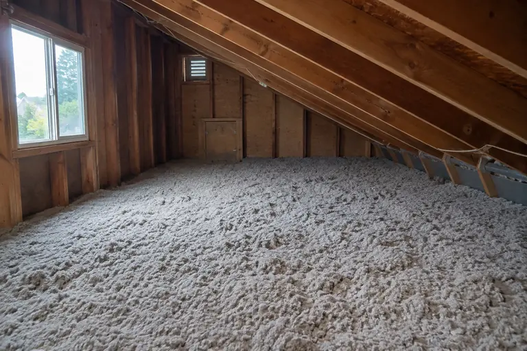 Attic insulation upgrade in Rainier Beach, after: The completed attic insulation upgrade with fully dense blown cellulose insulation and proper ventilation baffles in place.