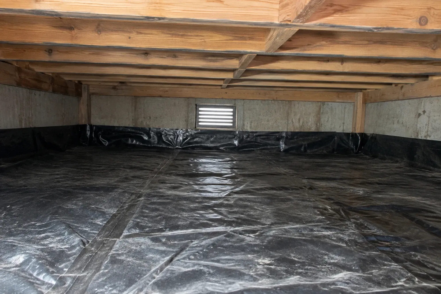 After: Finished cleaning reveals a debris-free crawl space with a clean dirt floor and unobstructed vent, significantly.