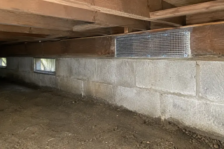 Crawl space cleaning with rodent-damaged sill plate repair, after: Finished repair: the damaged sill plate is fully sealed with rodent-proof mesh, and the crawl space is clean and protected.