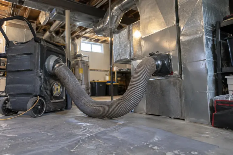 A negative-pressure vacuum machine is connected to a duct trunk line.