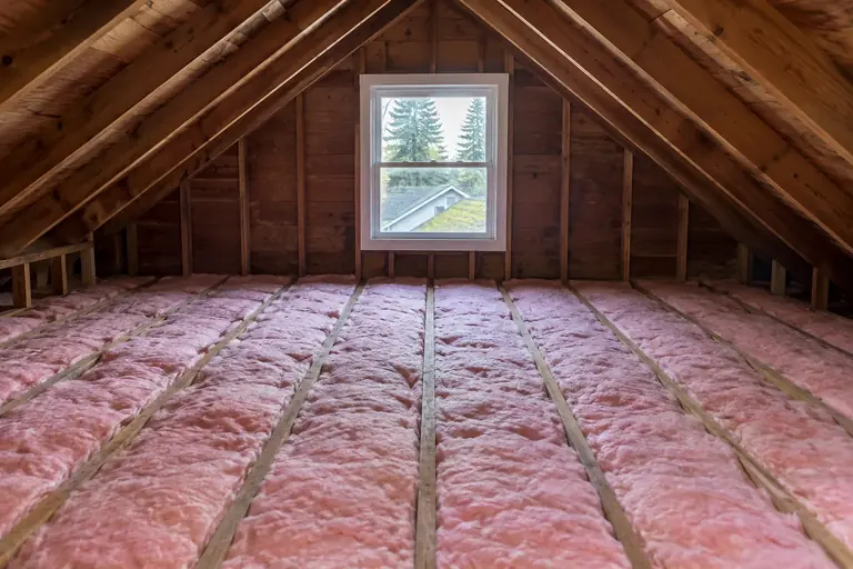 Attic insulation replacement in a Seattle Craftsman bungalow attic, after: The attic insulation replacement is complete, markedly.