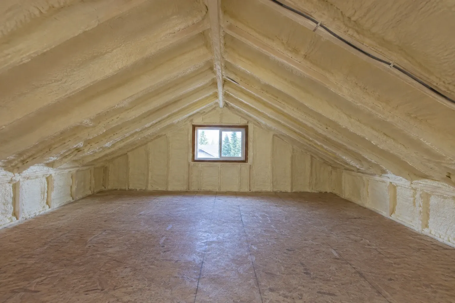 After: With insulation replacement complete, the attic cavity is fully sealed and insulated with closed-cell spray foam.
