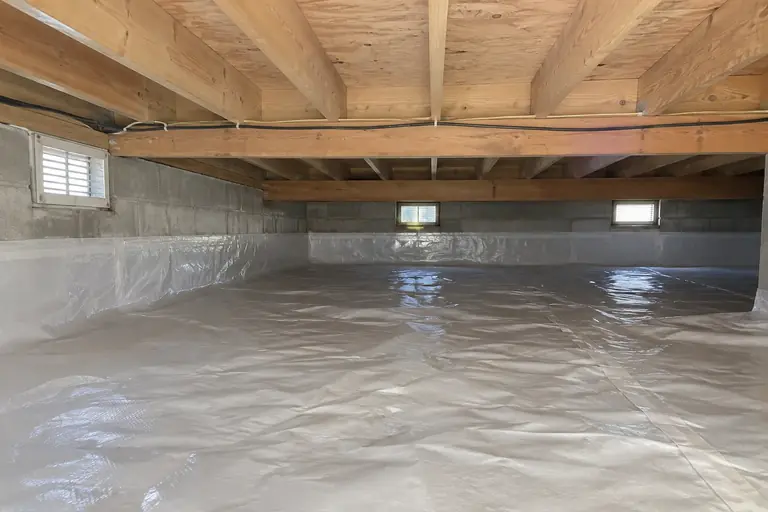 Mold remediation in Everett crawl space with ventilation mold, after: The crawl space joists are fully cleaned and protected, with a fresh vapor barrier in place and vents clear, completing the remediation.