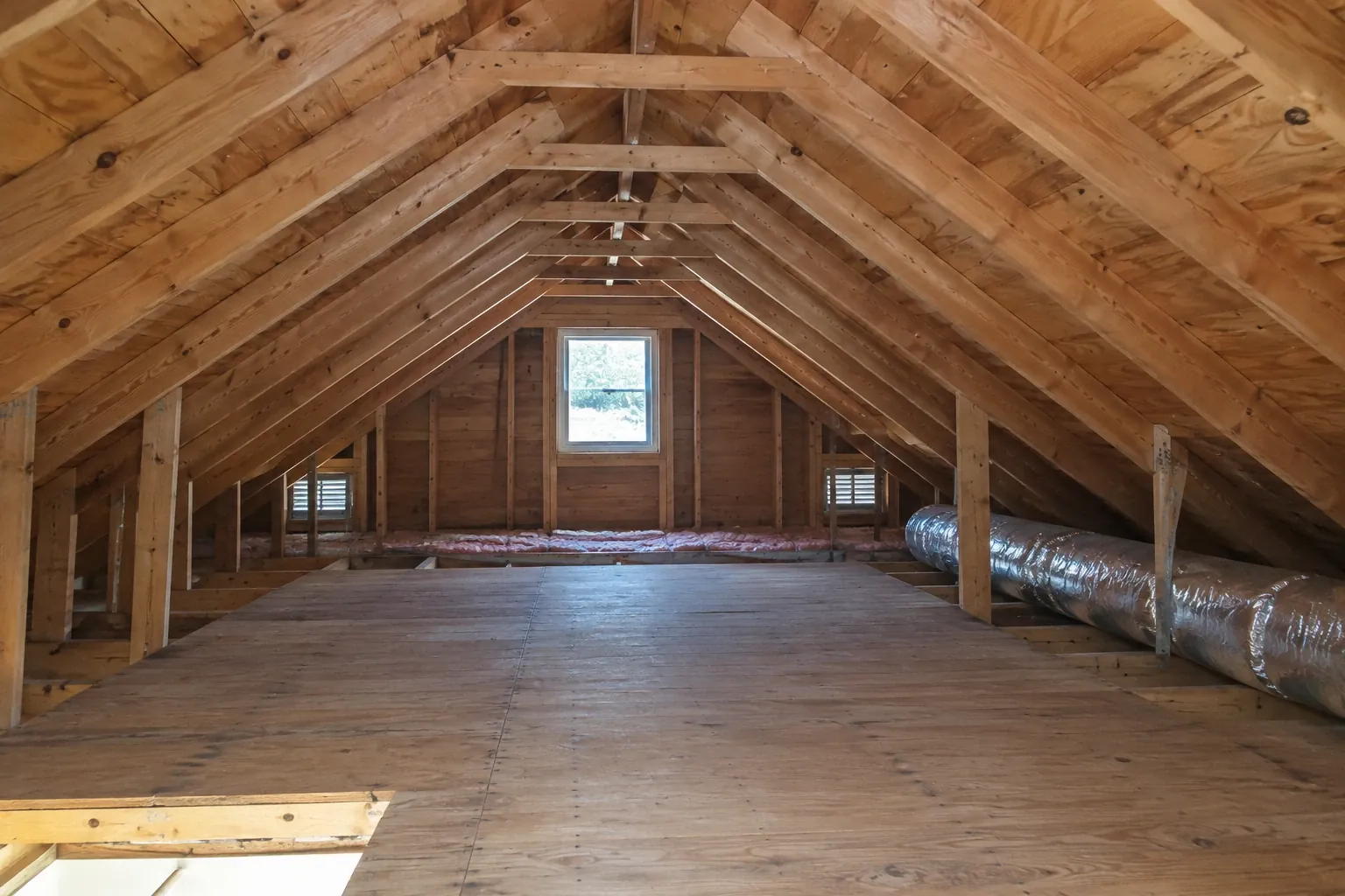 After: The attic roof is visibly clean and dry, with no trace of mold remaining on the sheathing or joists.